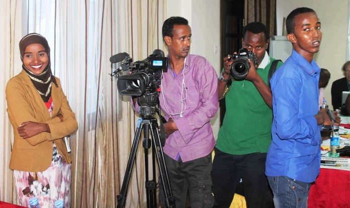 Photo File- Somali journalists stand during a media training conference in Mogadishu on May 2, 2015.