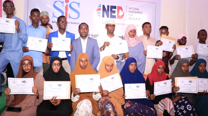 Participants pose for a group photo following the conclusion of a three-day human rights journalism training in Galmudug, Somalia on Saturday 11 June 2022