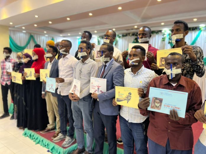 SJS Secretary-General Abdalle Mumin and local journalists gather for a protest to demand Mr. Mumin's freedom in Mogadishu on 5 December 2022.