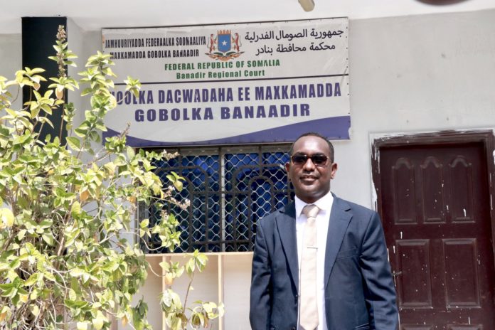 SJS Secretary-General, Abdalle Ahmed Mumin, stands outside the Banadir Regional Court on January 4, 2023.