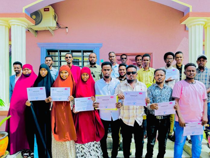 Journalists and officials pose for a group photo after completing a three-day journalists training on climate change reporting in Gedo region, June 14, 2023. | PHOTO/SJS.